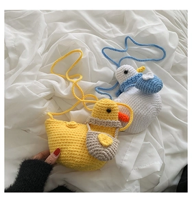 Detailed knit texture of cute handmade duck crossbody bags in yellow and white colors