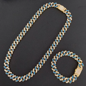 Detail of hip-hop gold Cuban chain set with blue enamel and sparkling rhinestones