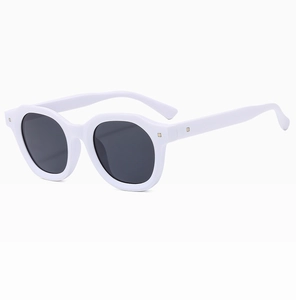 Detailed 3/4 view of retro white frame sunglasses with dark lenses and studded details