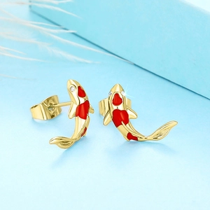 Detailed macro view of golden koi fish earrings with red enamel and zircon accents