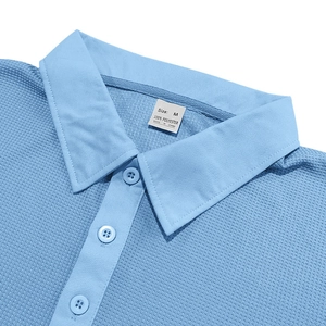 Detailed close-up of light blue waffle texture polo shirt collar and buttons