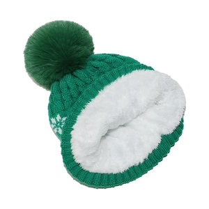 Detailed view of the thick faux fleece lining and snowflake pattern on winter knit hat