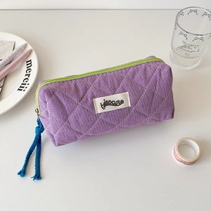 Detail of purple plaid quilted pencil case with green zipper and hisocute label