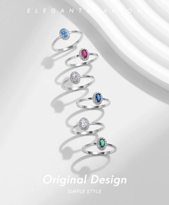 Detailed view of six stackable 925 silver rings with multi-color oval halo gemstones