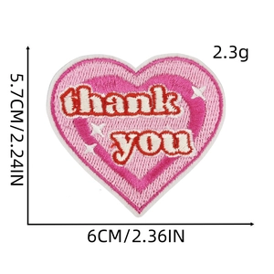 Detail view of heart-shaped pink embroidery patch with thank you text for clothing