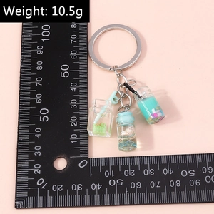 Miniature fruit bottle keychain weight measurement detail with ruler showing 10.5g size