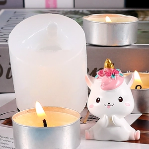 Detail view of unicorn silicone mold with finished resin statue and decorative tea lights