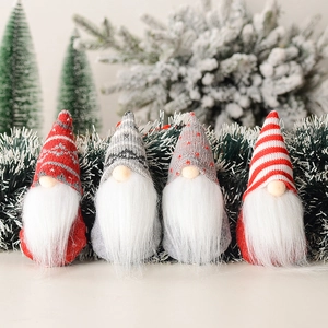 Set of four knitted Christmas gnomes with snowflake patterns for tree decoration
