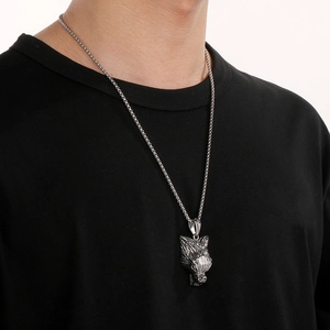 Detailed view of a punk style 3D wolf head pendant on a silver metal chain on a model