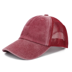 Detail of burgundy washed trucker hat featuring breathable mesh back and vintage texture
