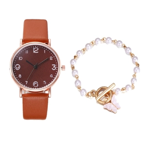 Brown leather strap watch with round dial and pearl bracelet featuring a butterfly charm