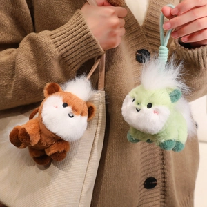 Plush animal charms in green and brown with fluffy white hair for bag accessories