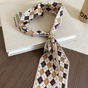 Detail of vintage brown plaid silk scarf necklace with a polished gold metal buckle clasp