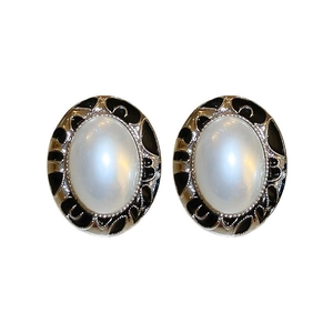 Elegant silver stud earrings featuring white oval pearls with black enamel scroll edges