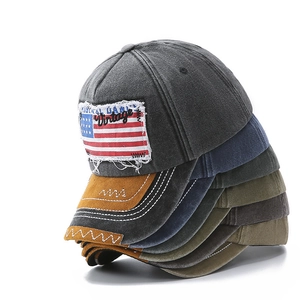 Multiple colors of vintage washed canvas baseball caps stacked on white background