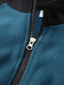 Close-up of tactical fleece jacket featuring contrast panels and durable resin zipper