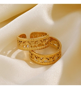 Close-up of 18K gold plated V-shaped ring with hollow star and moon patterns on satin