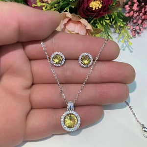 Elegant round yellow zircon necklace and earrings set with micro-pave diamond halo in silver