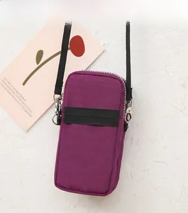 Detail of purple waterproof nylon phone crossbody bag with zipper and elastic strap