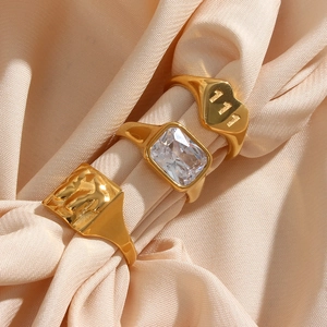 Three gold stainless steel rings set featuring heart 111, zircon, and textured square