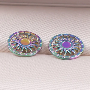 Macro view of rainbow stainless steel sun stud earrings in a beige jewelry box