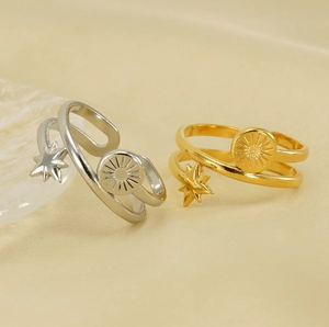 Detailed view of dual-layer stainless steel rings with celestial star and sun motifs