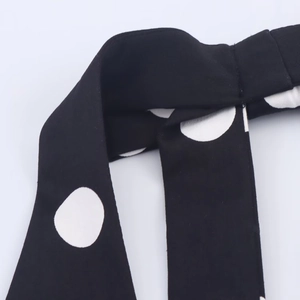Detailed view of black and white polka dot fabric texture with fine stitching finish