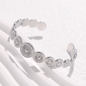 Retro geometric open silver bangle with embossed round sun patterns in stainless steel