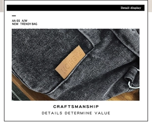 Macro view of washed denim crossbody bag featuring a brown leather label and fine stitching