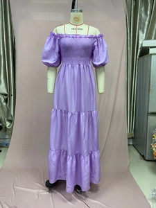 Detail of purple off-shoulder dress with smocked bodice and tiered ruffle skirt layers