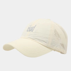 Detail of beige quick-dry cap showing grey Island embroidery and laser-cut vents