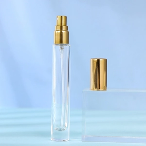 Detail of 10ml glass perfume spray bottle with premium gold metal cap and sprayer