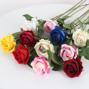 Vibrant multicolored velvet artificial roses with green leaves for home and wedding decor