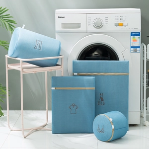 Detailed view of 5-piece mesh laundry bags with embroidery icons on a washing machine