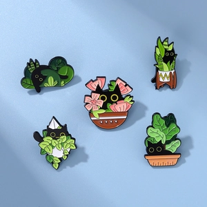 Detailed view of black cat enamel pins set with plants on light blue background