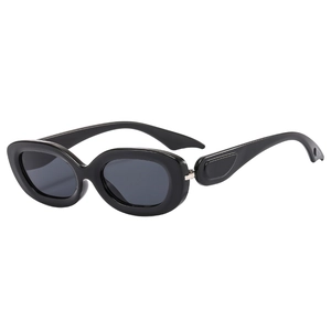 Retro oval black sunglasses with thick geometric temples and dark lenses on white background