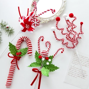 Christmas tree picks set with red and white peppermint candy canes and holly berries