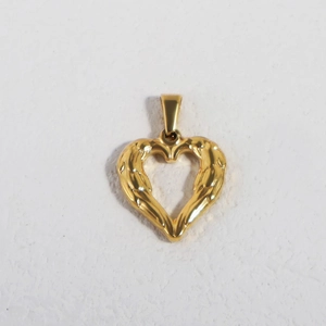 Detail of a 24K gold plated stainless steel heart pendant with textured surface