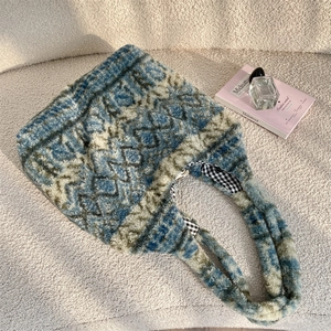 Detail of the blue and white geometric plush tote bag with a soft fuzzy texture