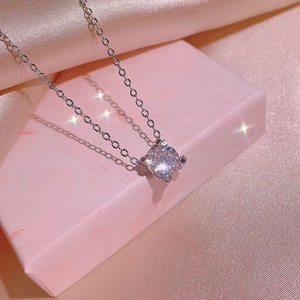 Elegant zircon solitaire necklace set with sparkling pendant on a pink gift box display