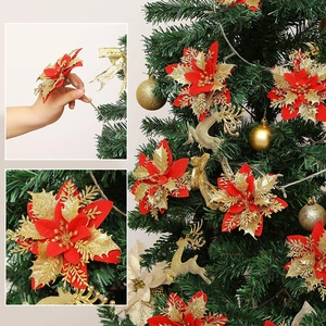 Close-up of artificial gold-powdered Christmas flowers on tree with red and gold details