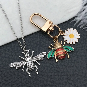Golden bee pendant with white daisy keychain and silver honeybee necklace set