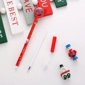 Close-up of red Christmas elk sequin pen with nutcracker and snowman holiday stationery