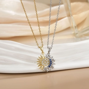 Macro view of sun and moon couple necklaces with zircon inlay on silk background