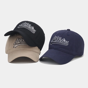 Close-up of high-density cotton baseball caps with Athletics embroidery and fine stitching