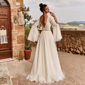 Bohemian white lace A-line wedding dress with open back and dramatic bell sleeves
