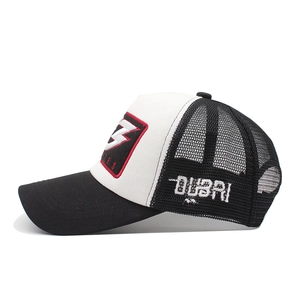 Side view of black and white mesh trucker hat with red Z patch and Dubai embroidery