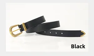 Detailed shot of black leather belt with vintage gold twisted buckle and metallic tip