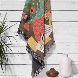Close-up of woven Christmas tree blanket showing detailed fabric texture and colorful fringes