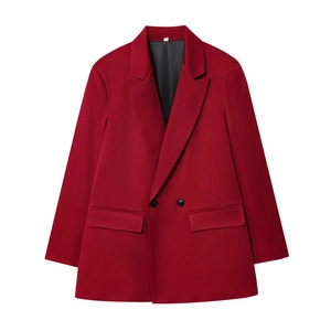 Detailed view of red double-breasted blazer showing fabric texture and flap pockets